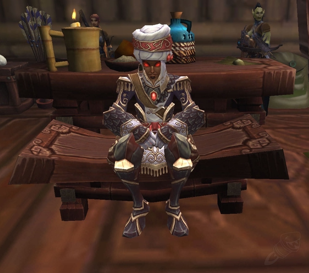 Wrathion seated at the Tavern of the Mists in Pandaria, calmly resting at a table in the inn. His imposing presence contrasts with the cozy, rustic atmosphere of the tavern